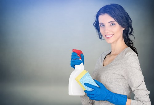 Local cleaner preparing bedding and surfaces in an Earlscourt Airbnb